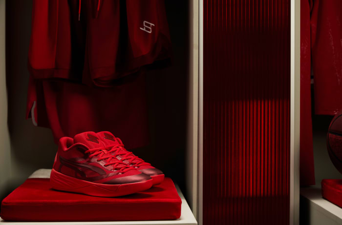 Side view of red Puma basketball shoes.